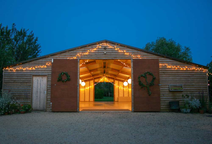 Fairy lights outline the barn and coffee shop